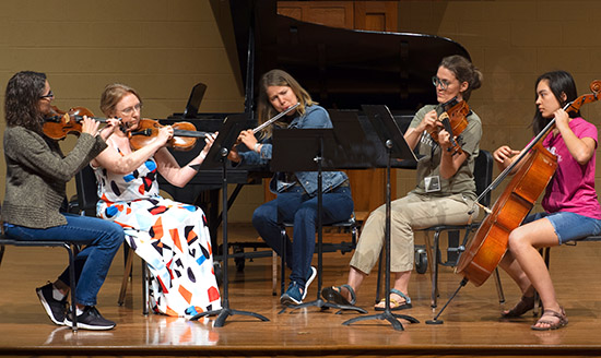 group playing flute quartet